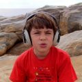 Child with autism wearing ear defenders
