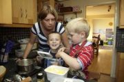 Mother and children with autism in a kitchen