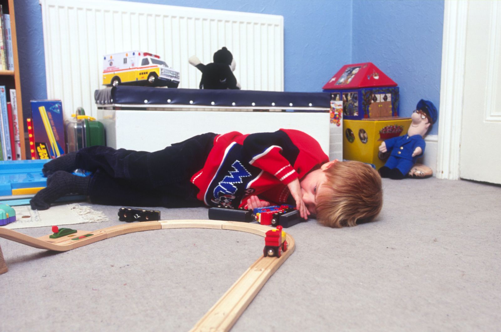 Boy playing with a train set